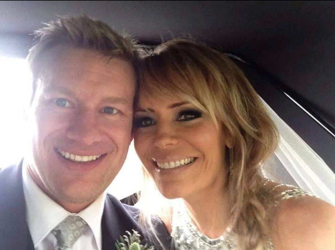 Happy blonde couple smiling at camera