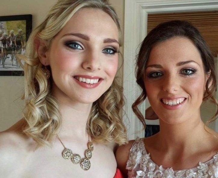 2 women smiling at camera in bridal wear