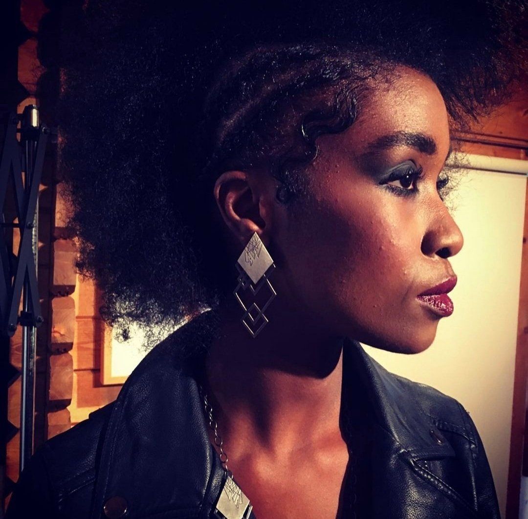 Side view of woman with afro pouting