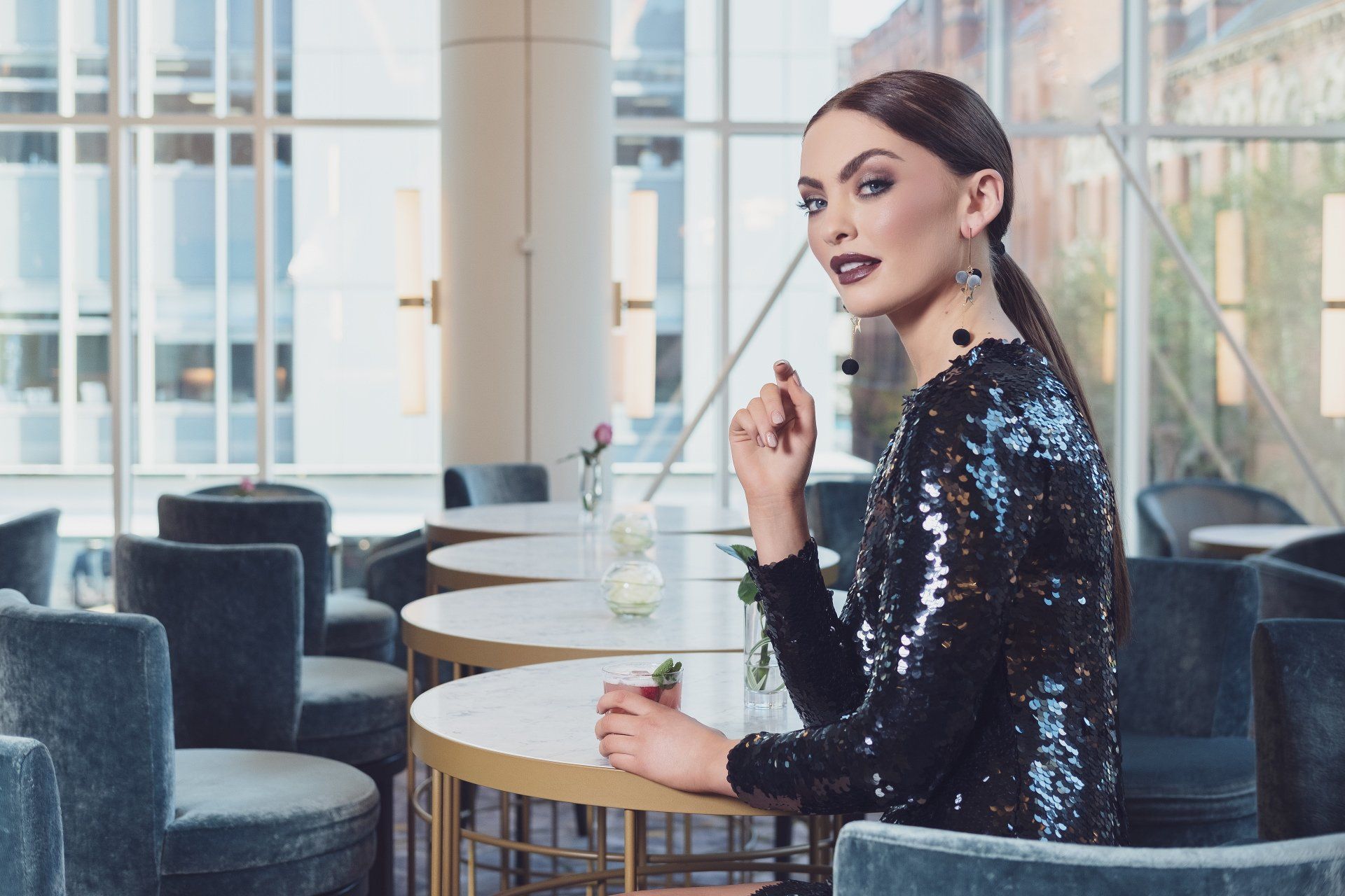 Woman in sequined dress sat at table