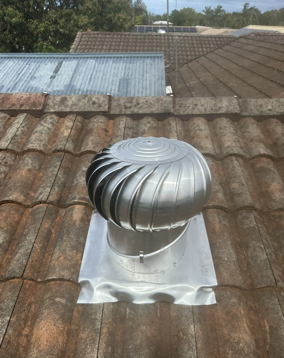 Silver Whirly Bird Vent on a Terracotta Tiled Roof — Whirly Bird King in Caloundra, QLD