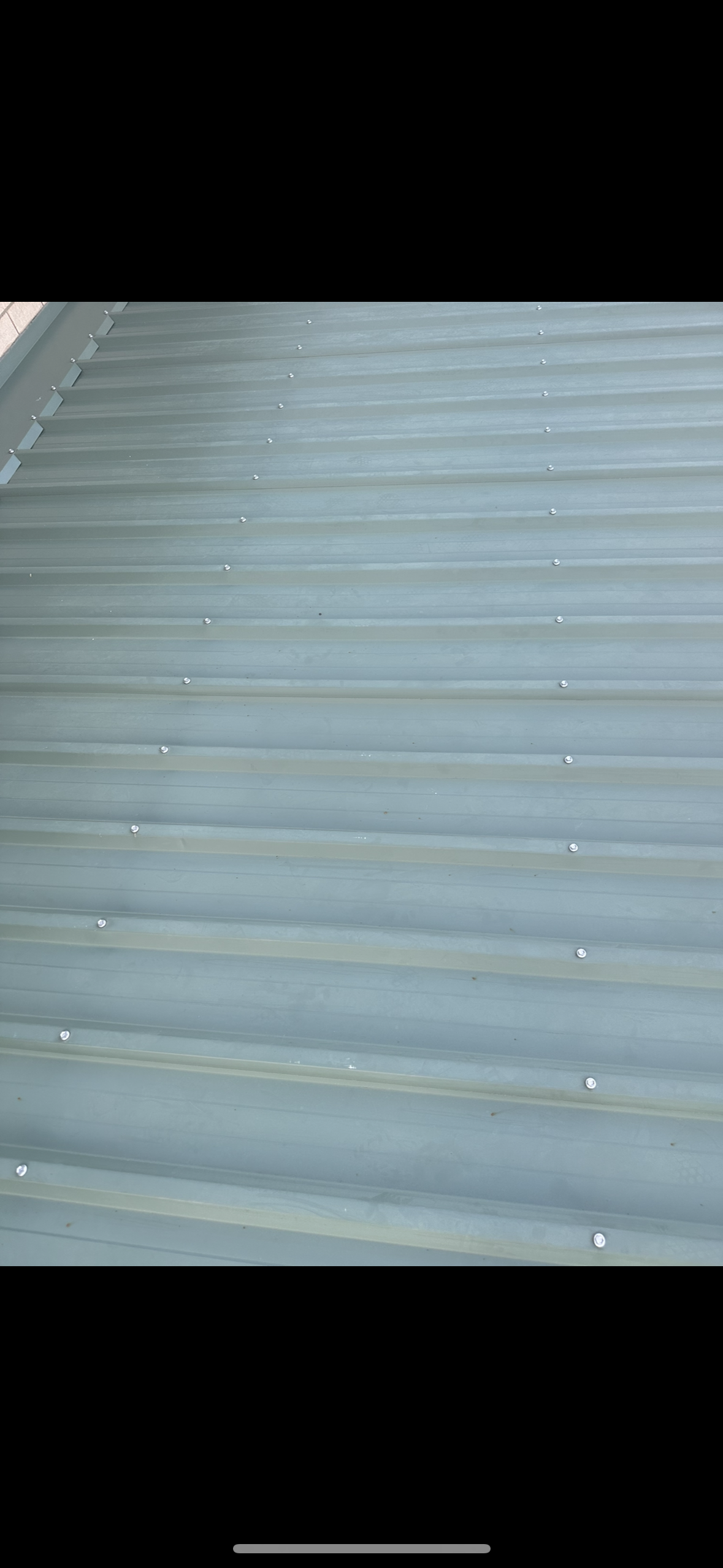 A Close-up of a Corrugated Metal Roof, Teal in Color, With Rows of Visible Screws — Whirly Bird King in Sunshine Coast, QLD