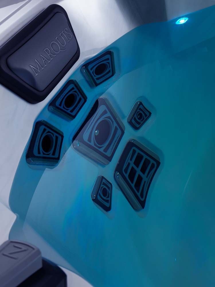 A close up of a hot tub with blue water.