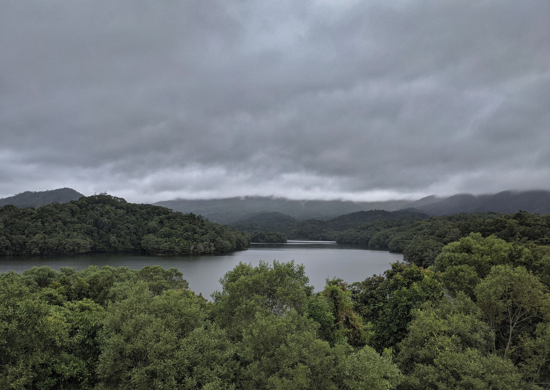 Overcast Day Over A Lake Surrounded By Lush Green Trees And Hills — LM Engineering In Georgetown, QLD