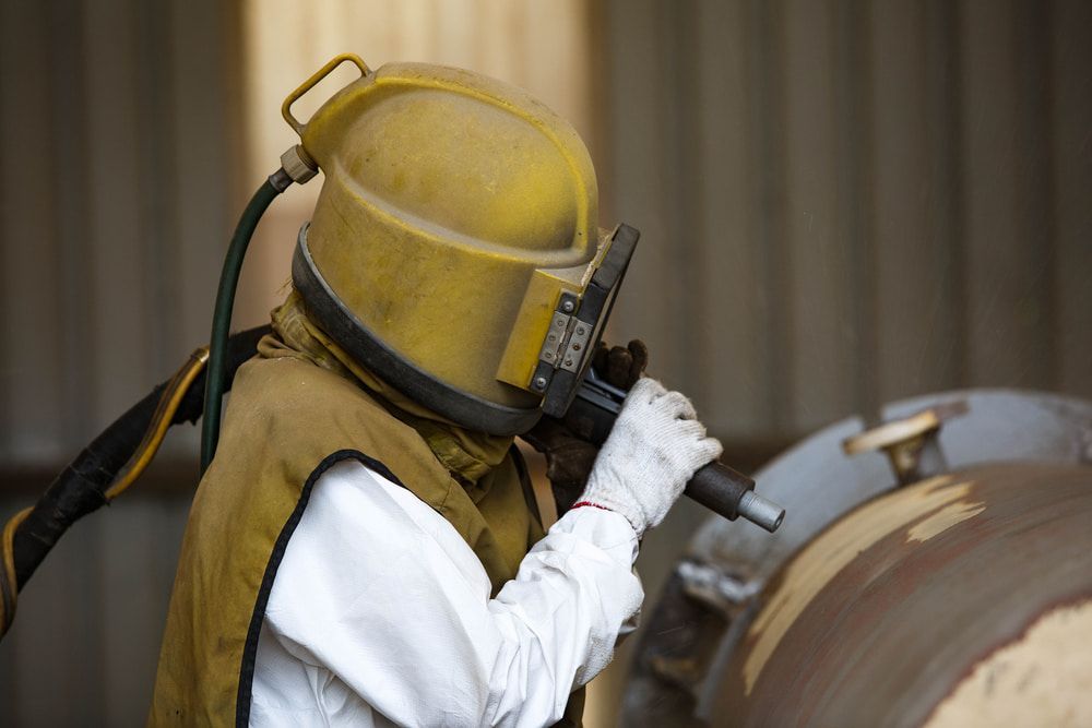 Person in a Yellow Sandblasting Helmet and Suit — LM Engineering in Georgetown, QLD