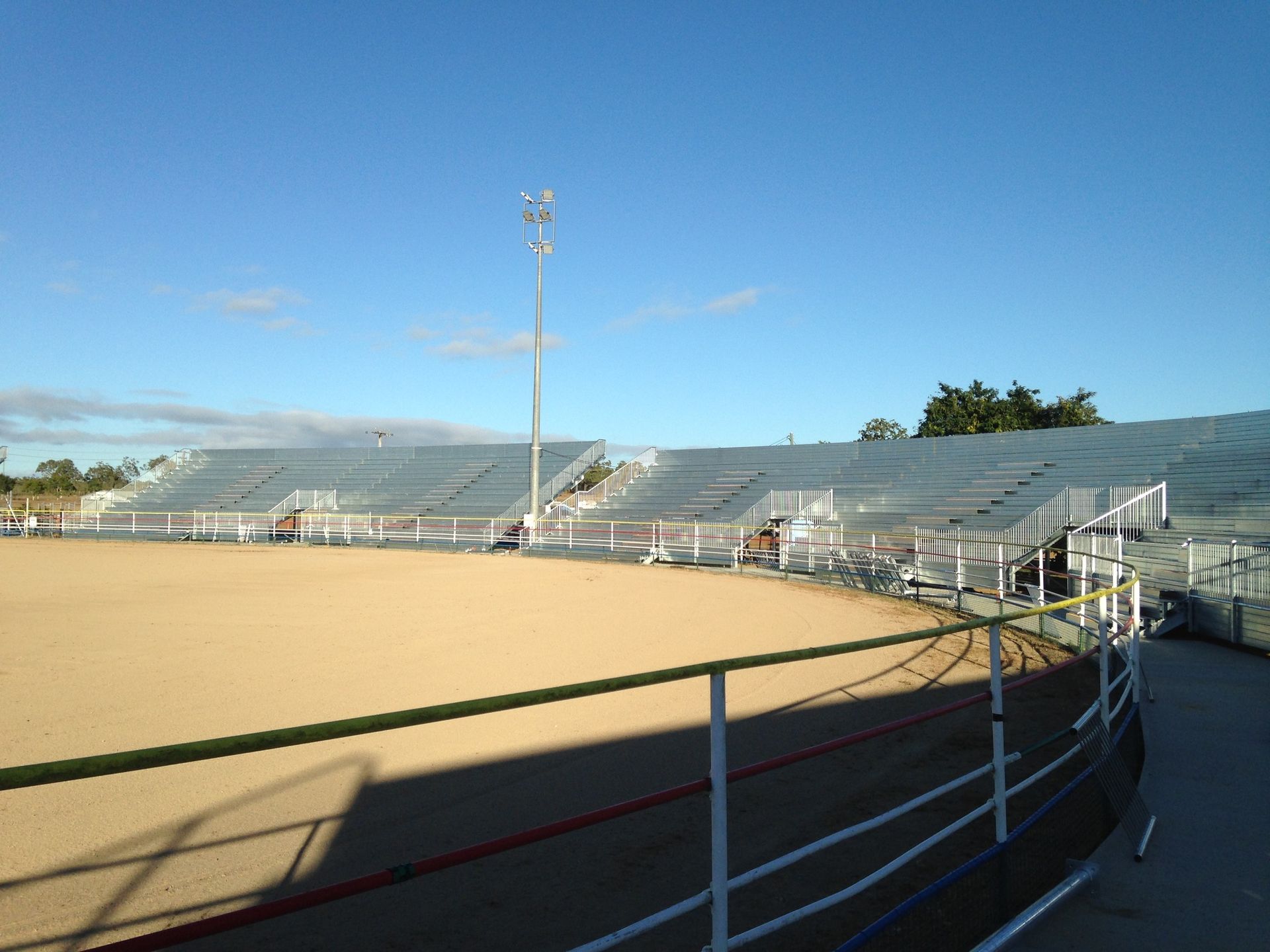 Empty Rodeo Arena With Tiered Seating Under a Clear Blue Sky — LM Engineering In Atherton Tablelands, QLD
