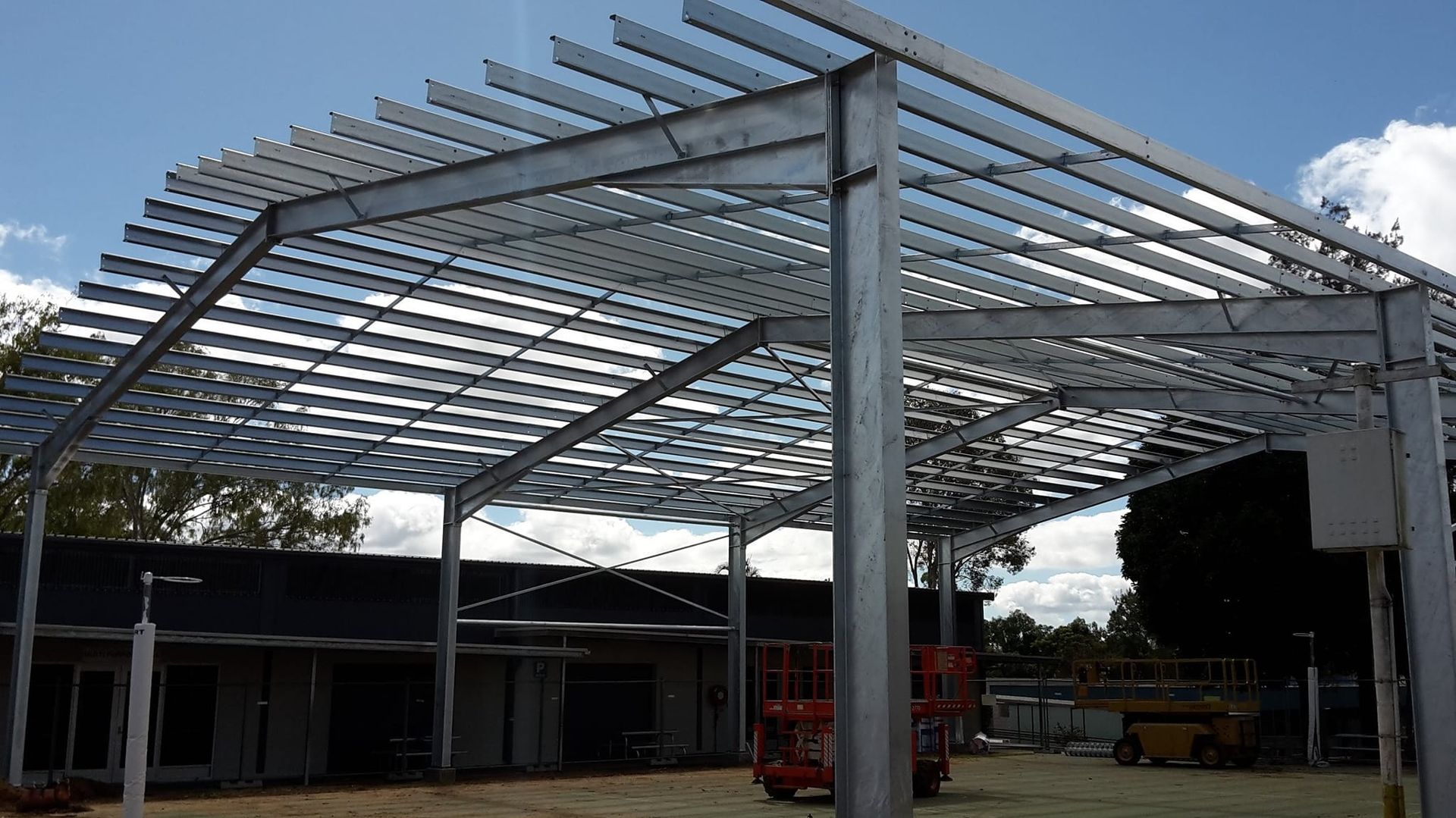Steel Frame Construction of a Building With a Flat Roof Under a Blue Sky — LM Engineering In Atherton Tablelands, QLD