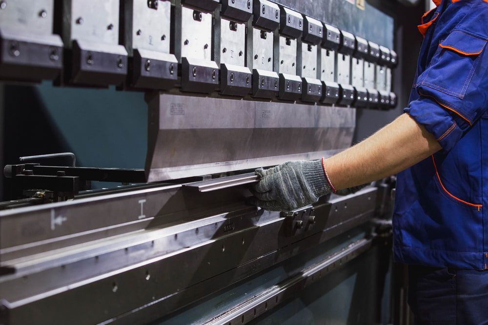 A Worker Operating a Metal Bending Machine in a Factory — LM Engineering in Cooktown, QLD