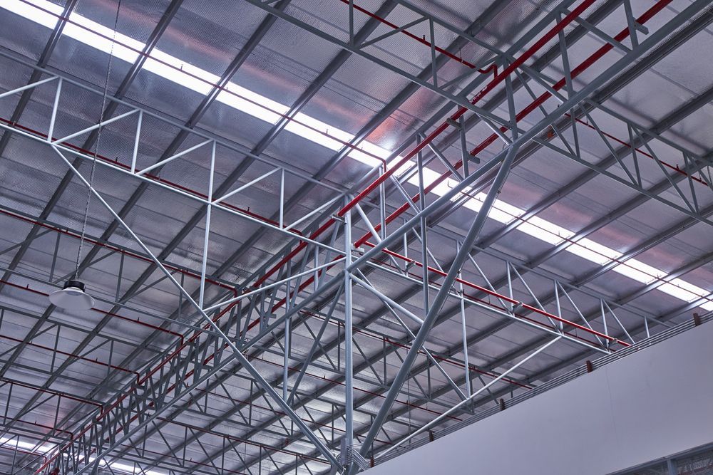 The Ceiling of a Large Building With a Lot of Metal Beams — LM Engineering In Mareeba, QLD