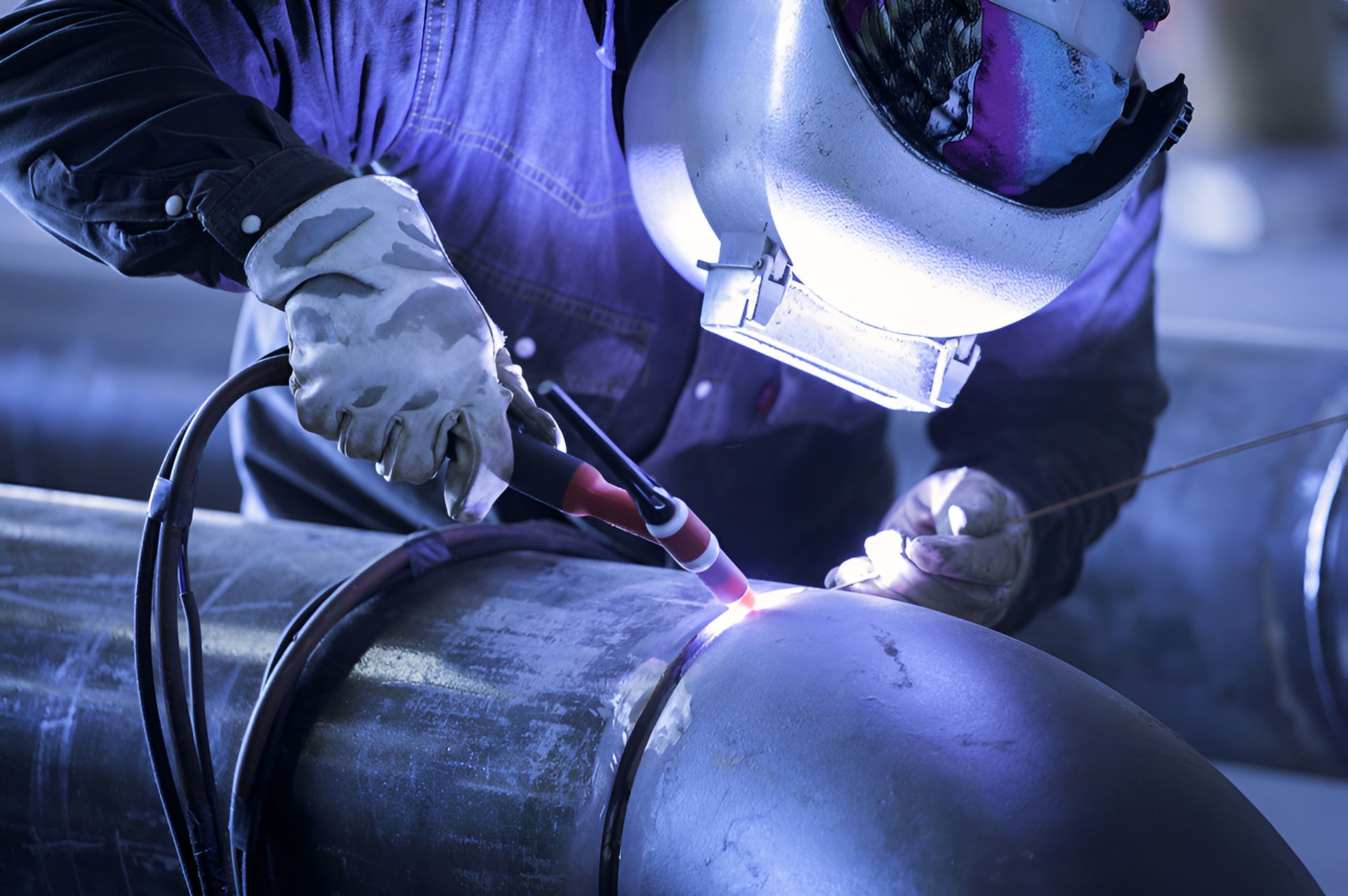 Welder in Protective Gear Welding a Pipe in a Workshop — LM Engineering in Cooktown, QLD