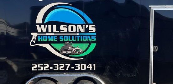 A wilson 's home solutions logo is on the side of a trailer
