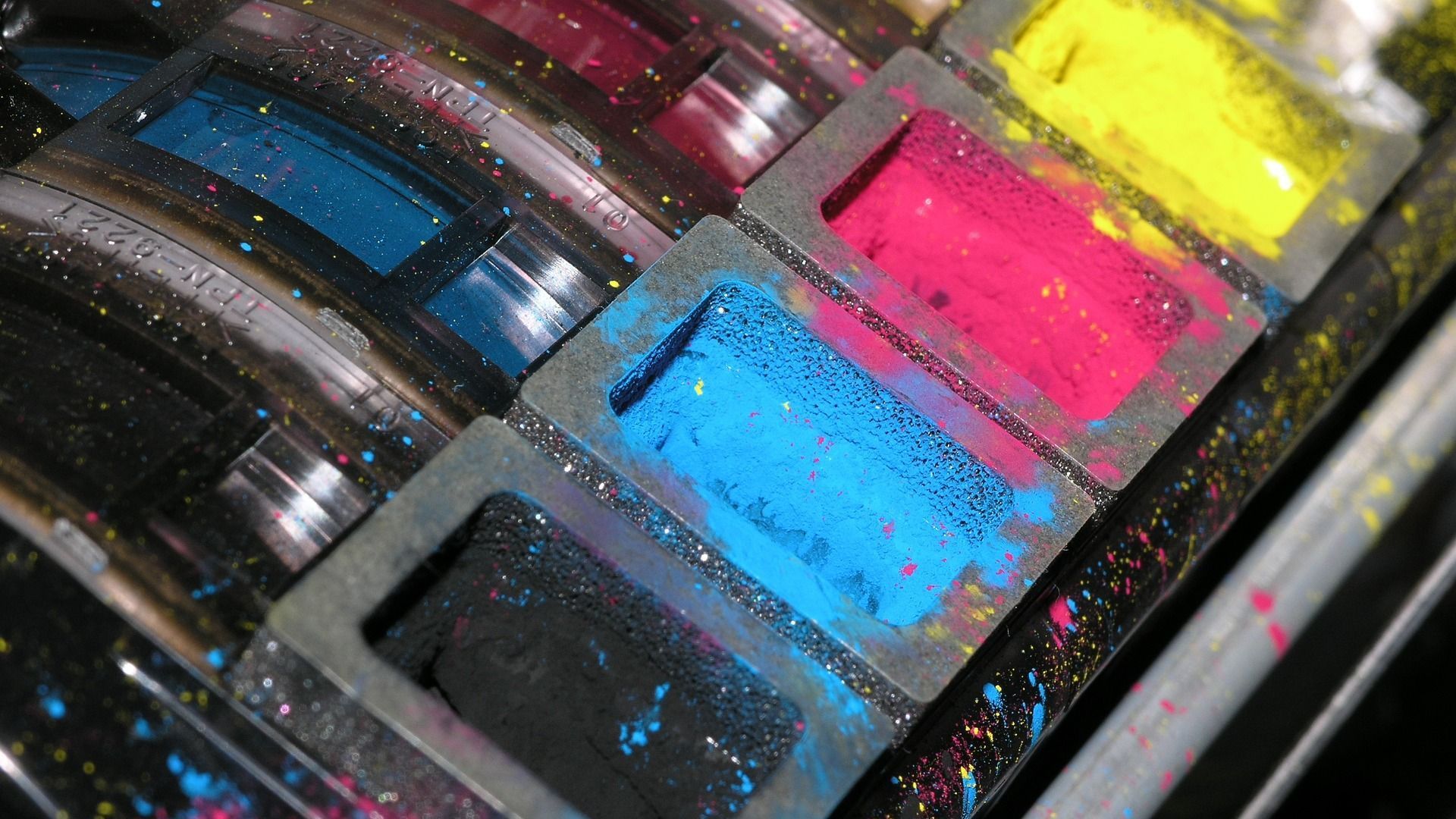 Printer with pools of CMYK.