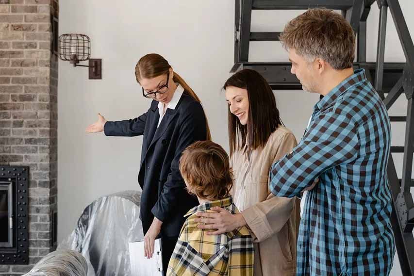 A family is looking at a house with a real estate agent.