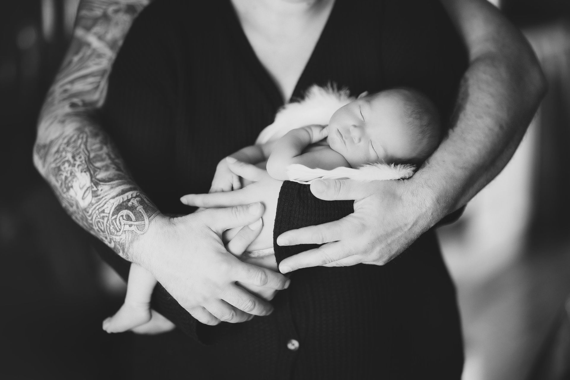 A black and white photo of a woman holding a newborn baby.