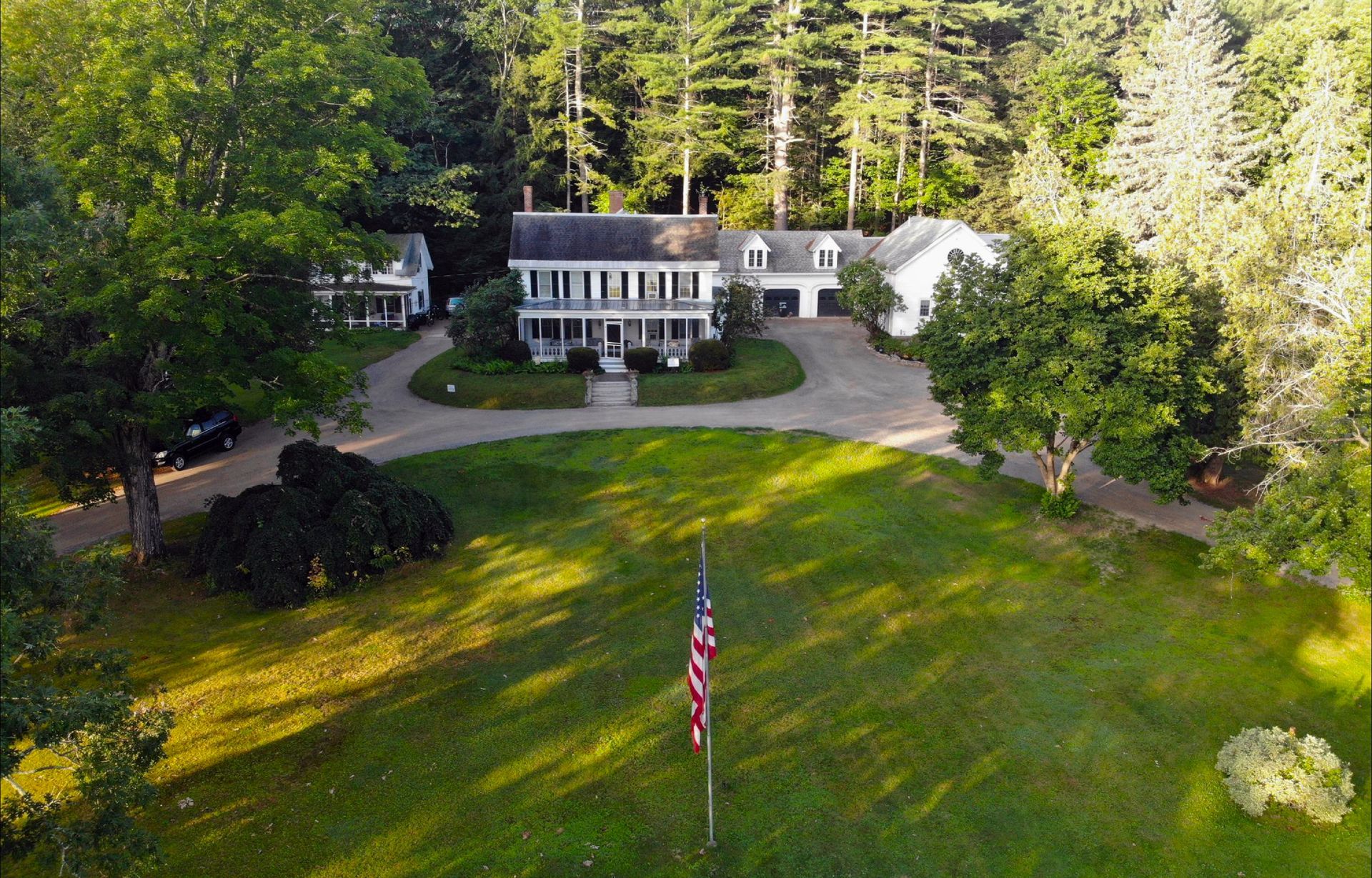 an aerial view of a house with an american flag in front of it