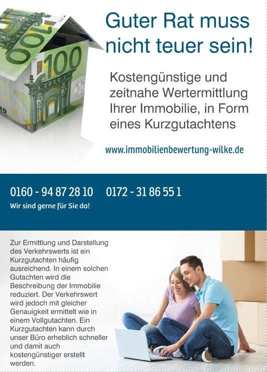 Ein Mann und eine Frau sitzen auf dem Boden und schauen auf einen Laptop.