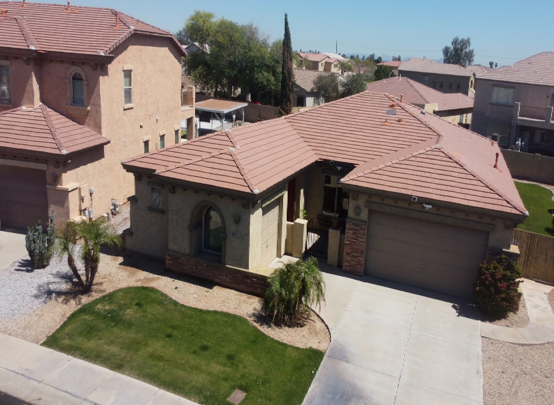 An aerial view of a house with a brown roof