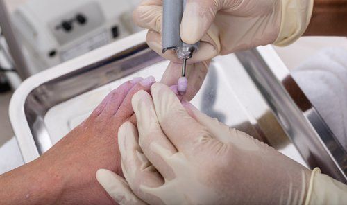 Podiatrist examining and treating patient's foot