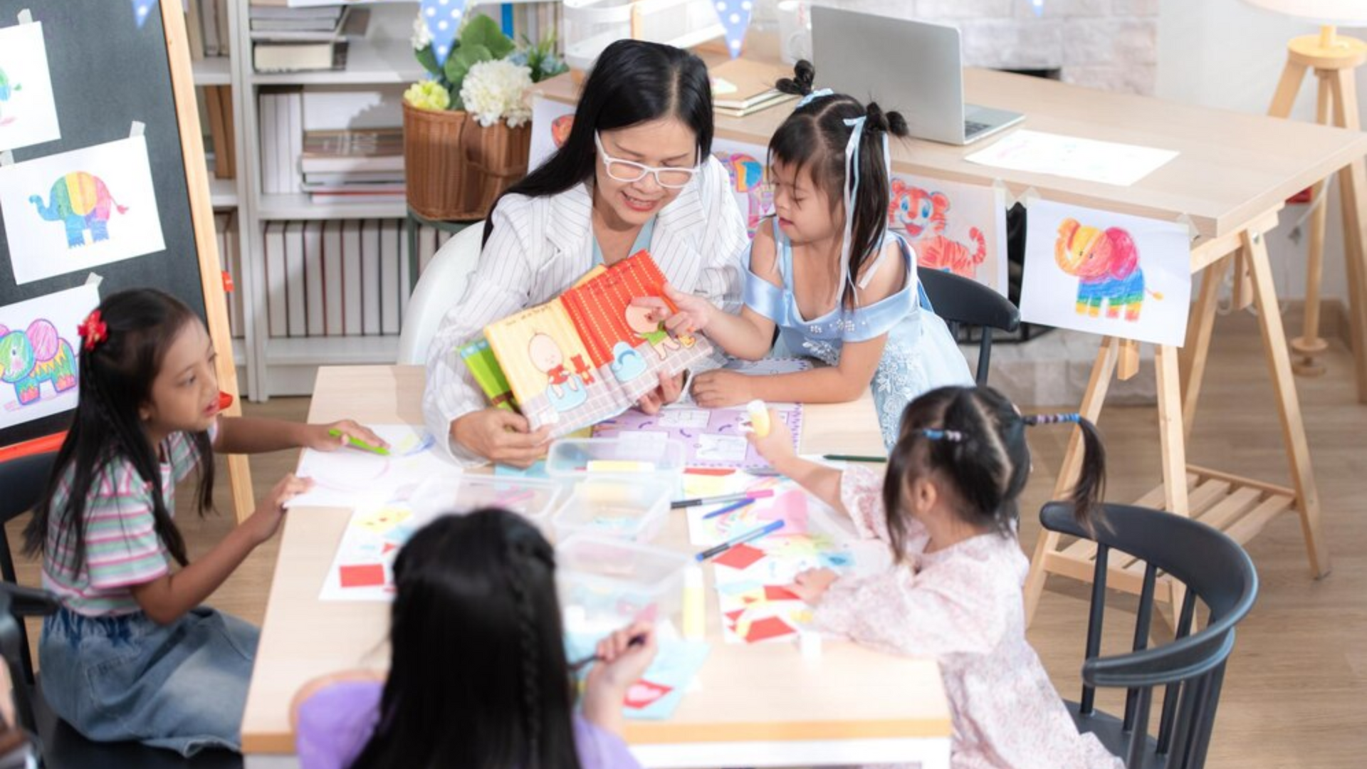 A teacher is reading a book to a group of children.