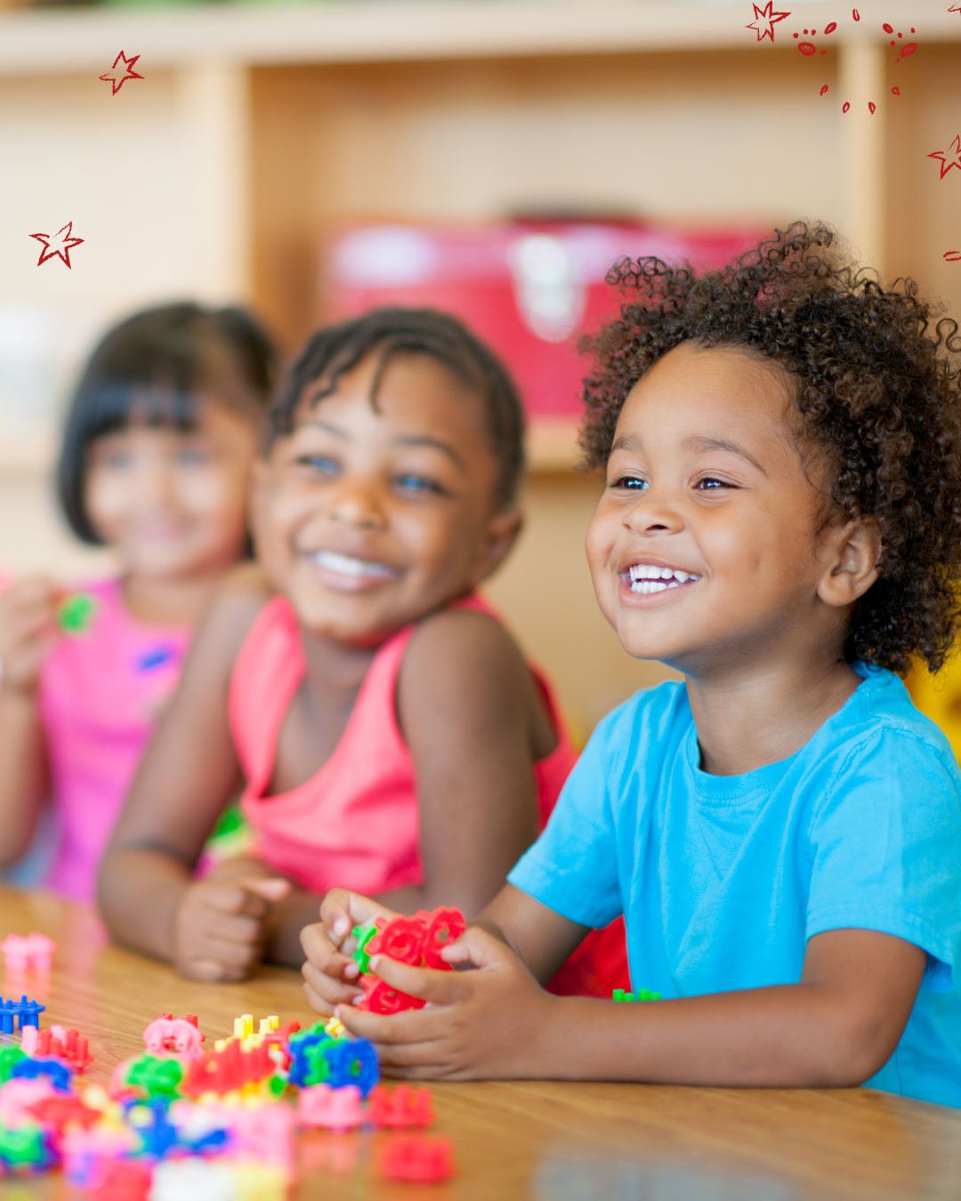 Boy in red shirt with arms crossed, smiling broadly, surrounded by colorful doodles.