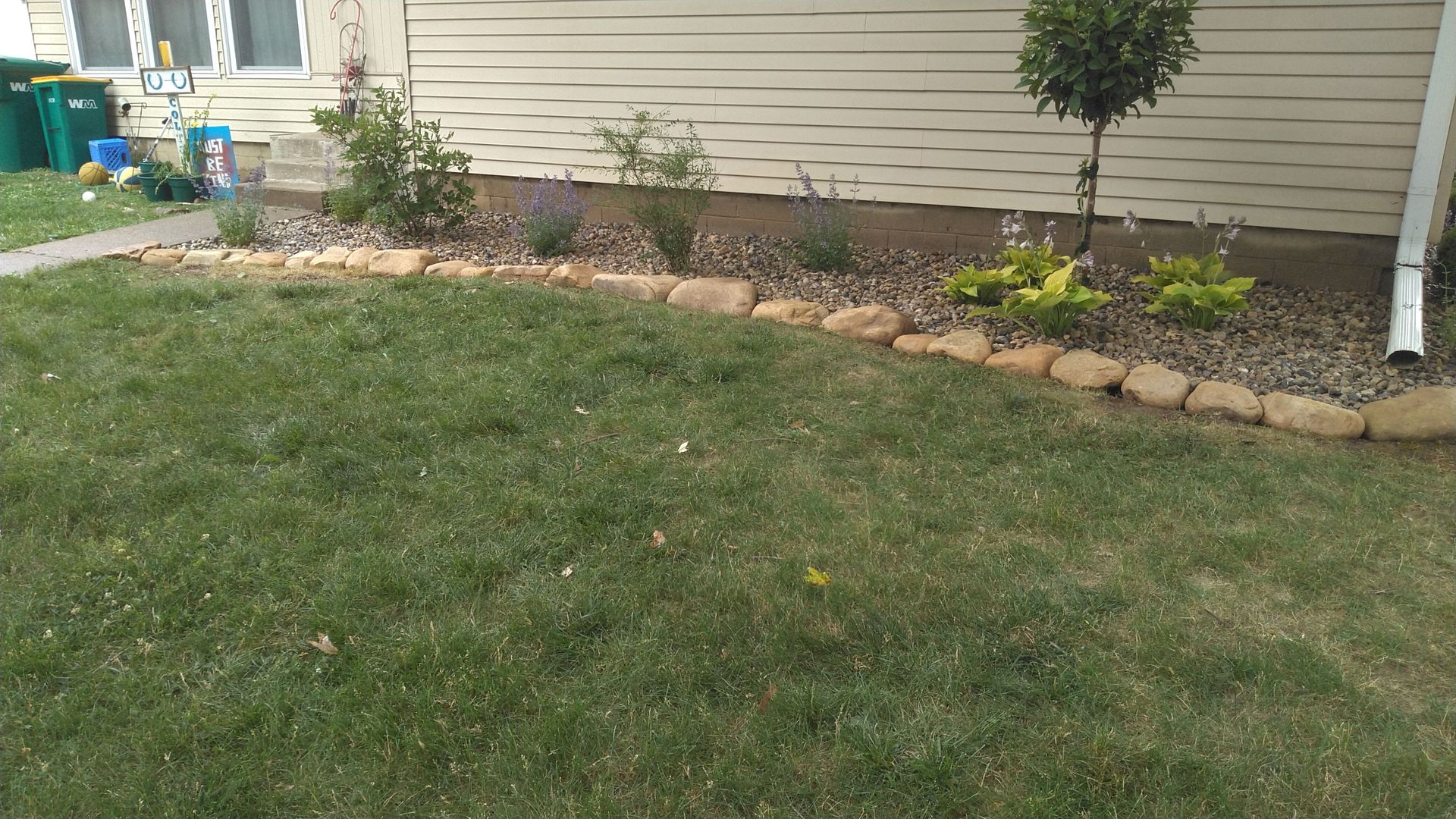 A lush green lawn is in front of a house.