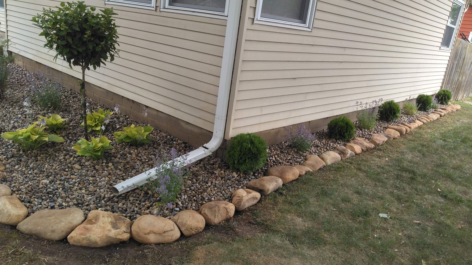A house with a drain pipe on the side of it.