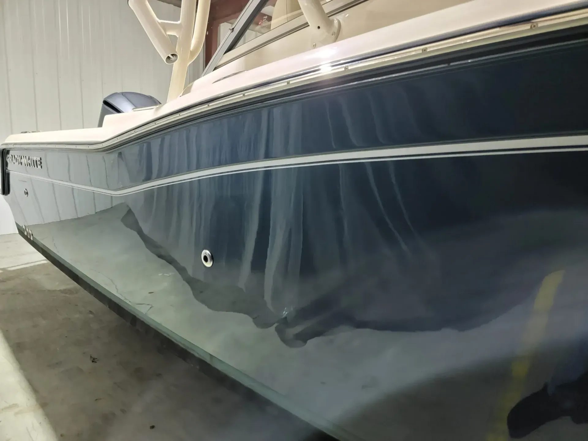A boat is sitting on the ground in a garage.