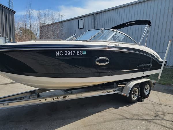 A boat with a license plate that says nc 2917 eg is parked in front of a building.