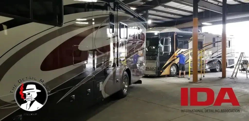 A group of rvs are parked in a garage.
