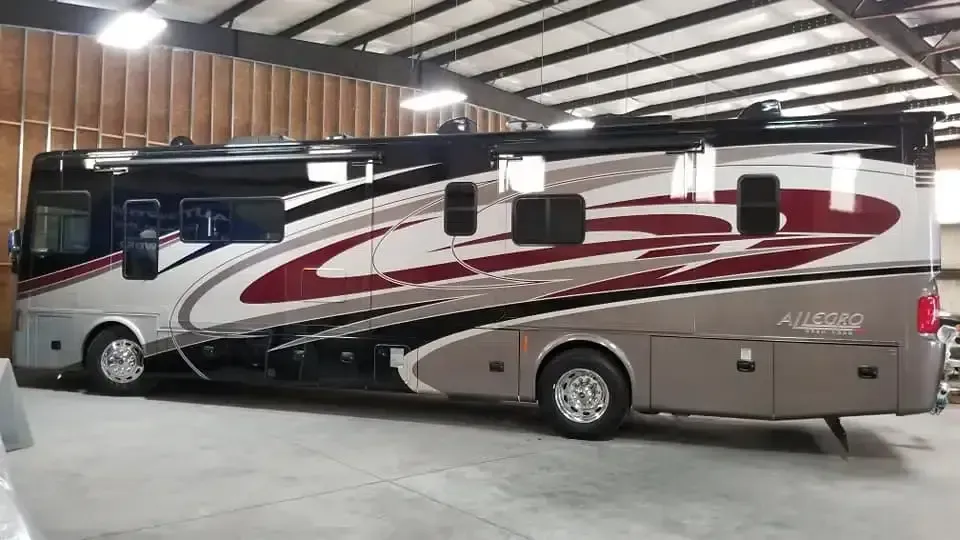 A large rv is parked in a garage.