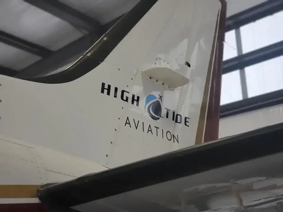 A high tide aviation plane is sitting in a hangar