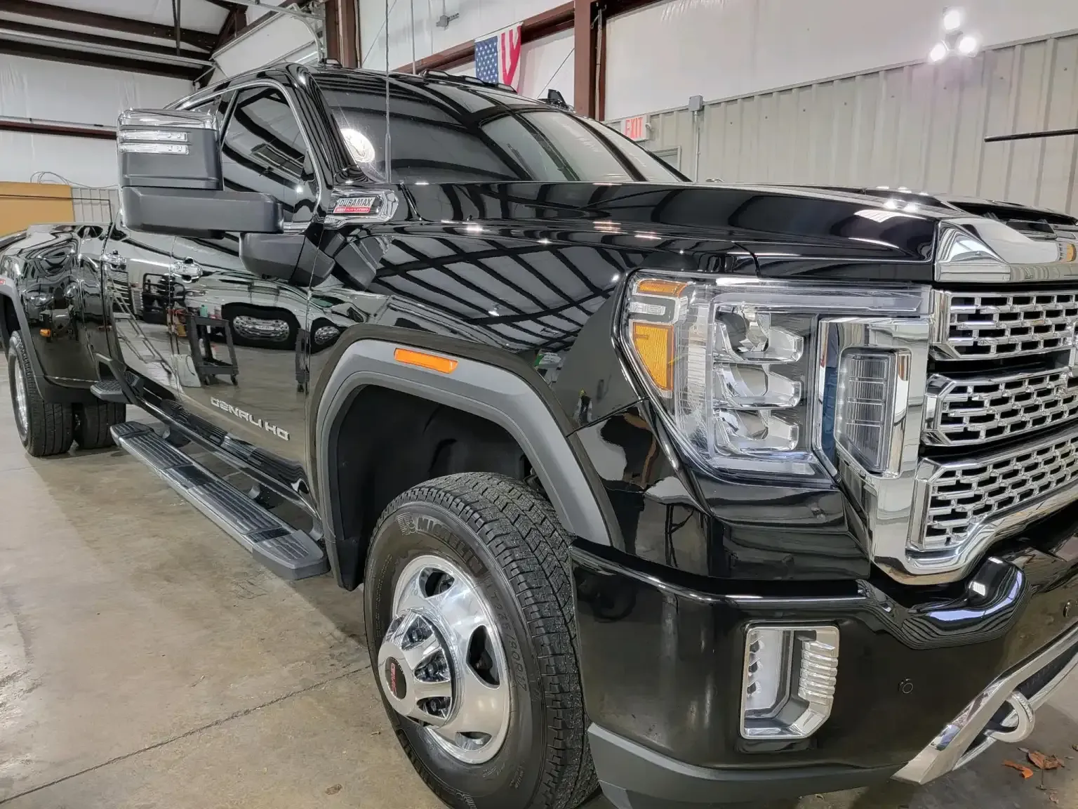 A black pickup truck is parked in a garage.
