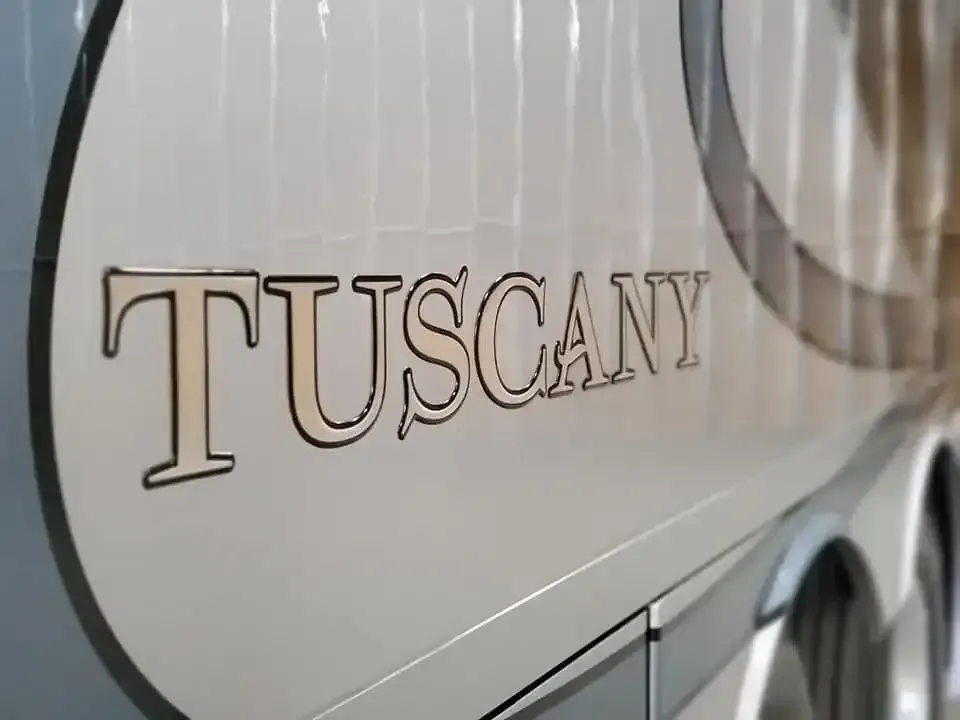 A close up of the side of a tuscan rv