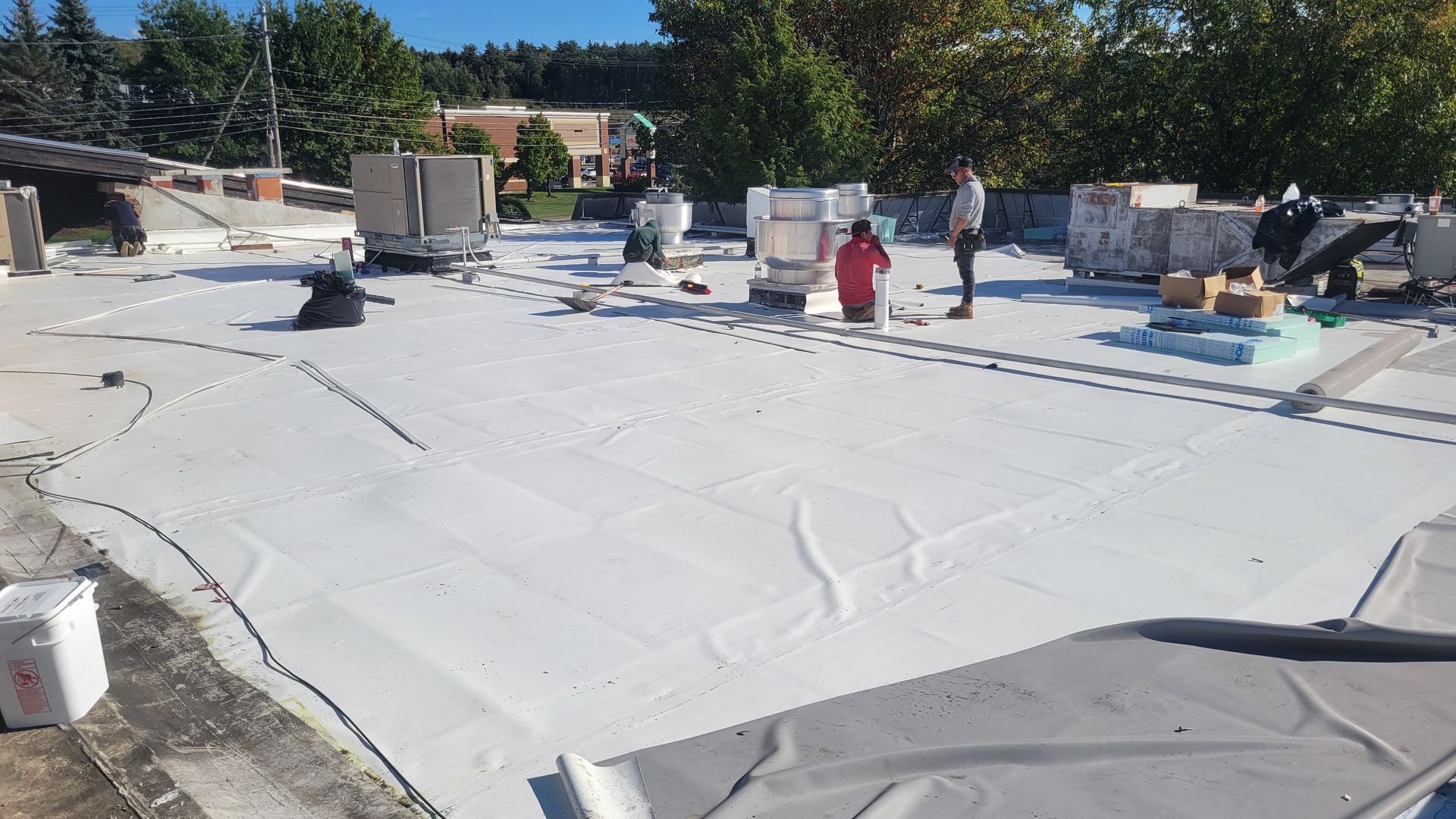 A white roof is being installed on top of a building.