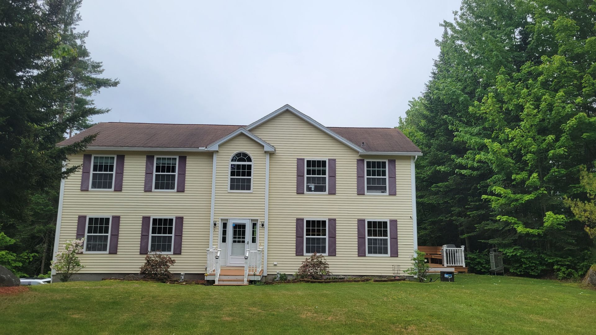 A large house with a lot of windows and shutters