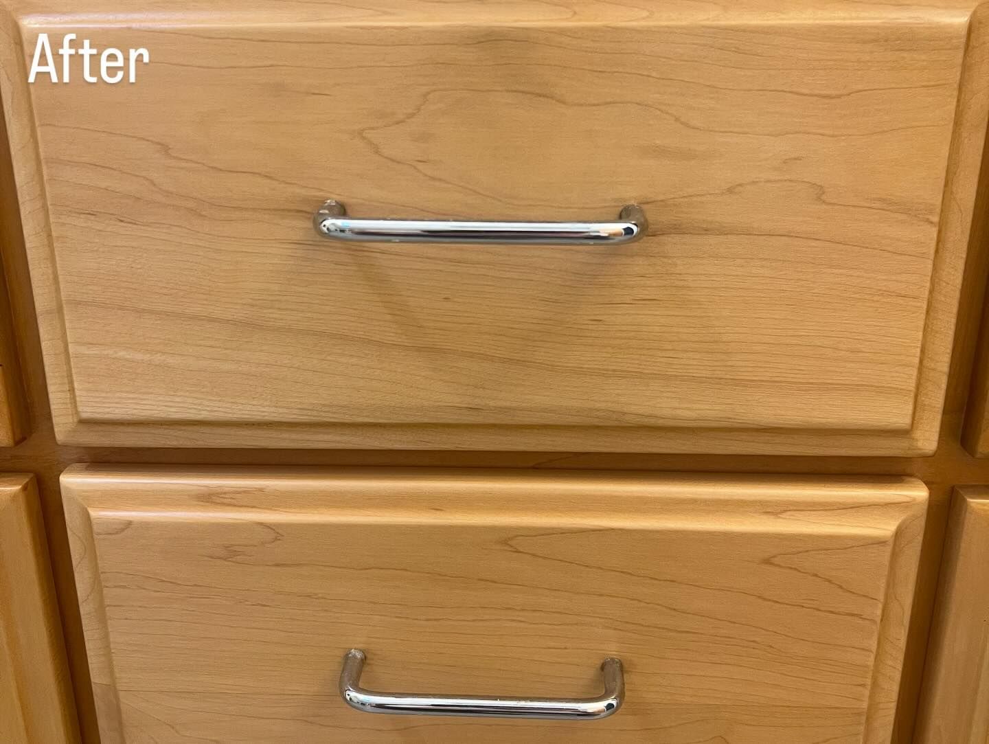 Living room with fireplace, tan leather sofa, blue chairs, and large windows.