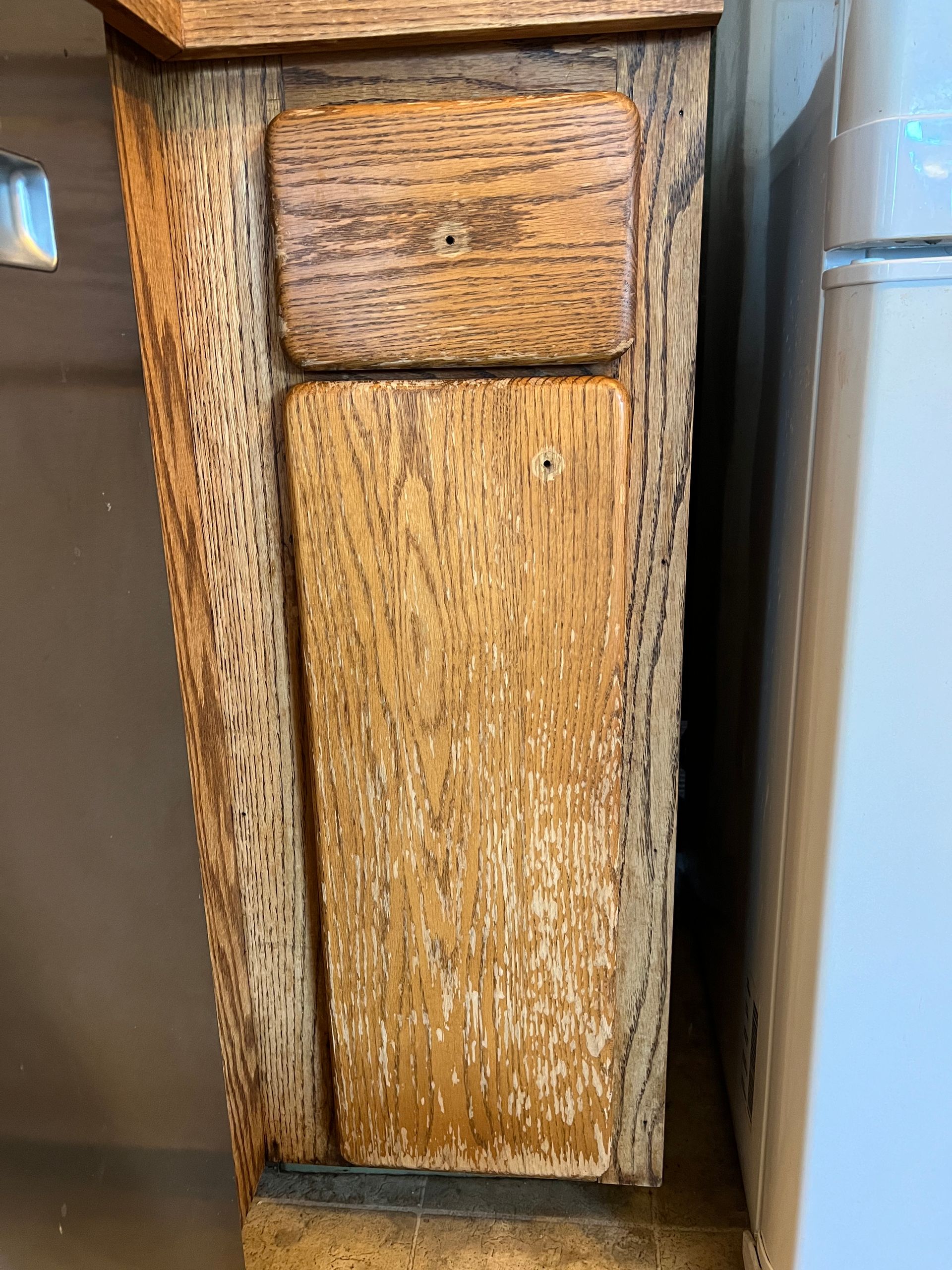 Wooden cabinet with two panels and visible wood grain.