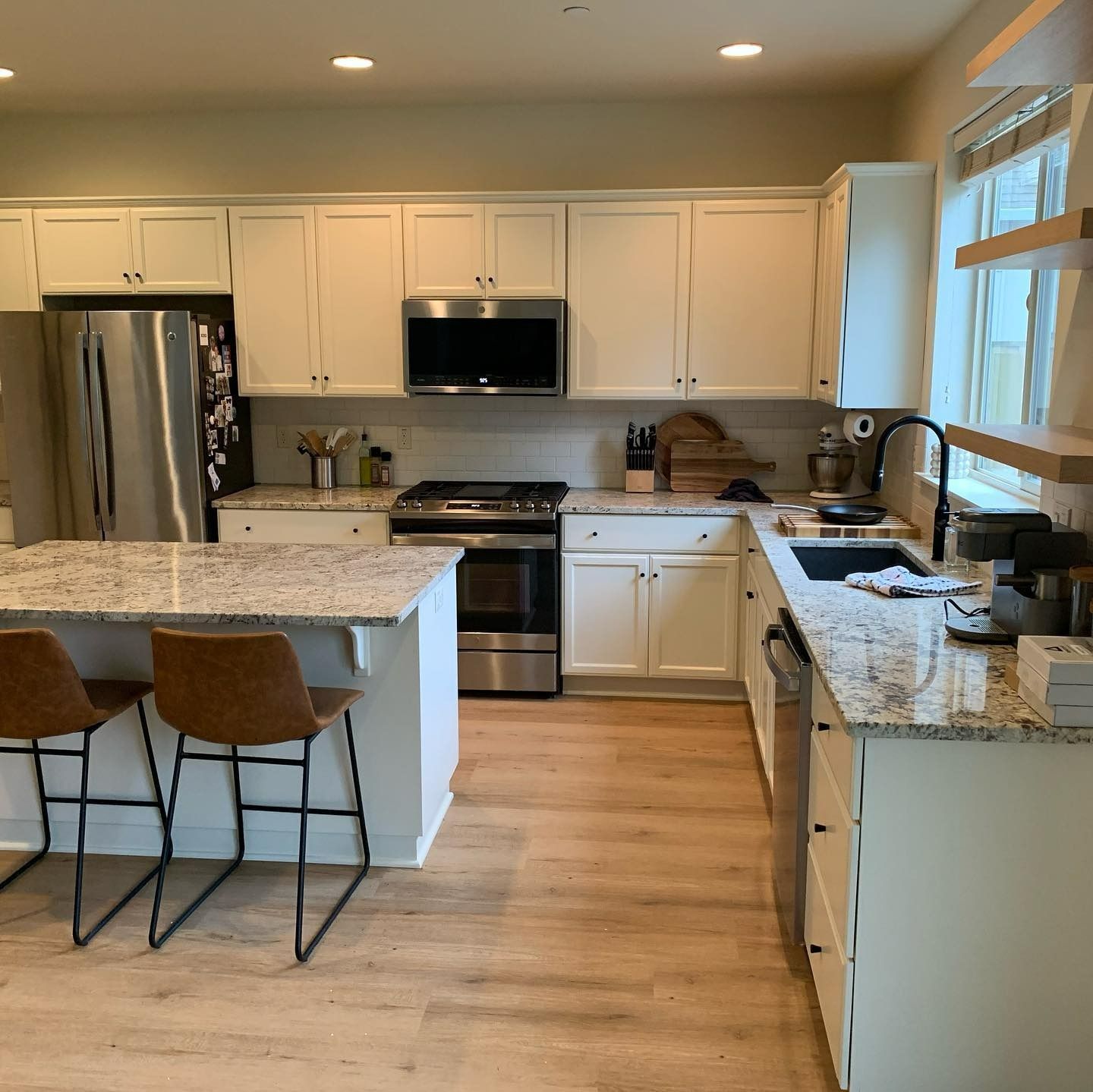 Kitchen with white cabinets, stainless steel appliances, and granite countertops.