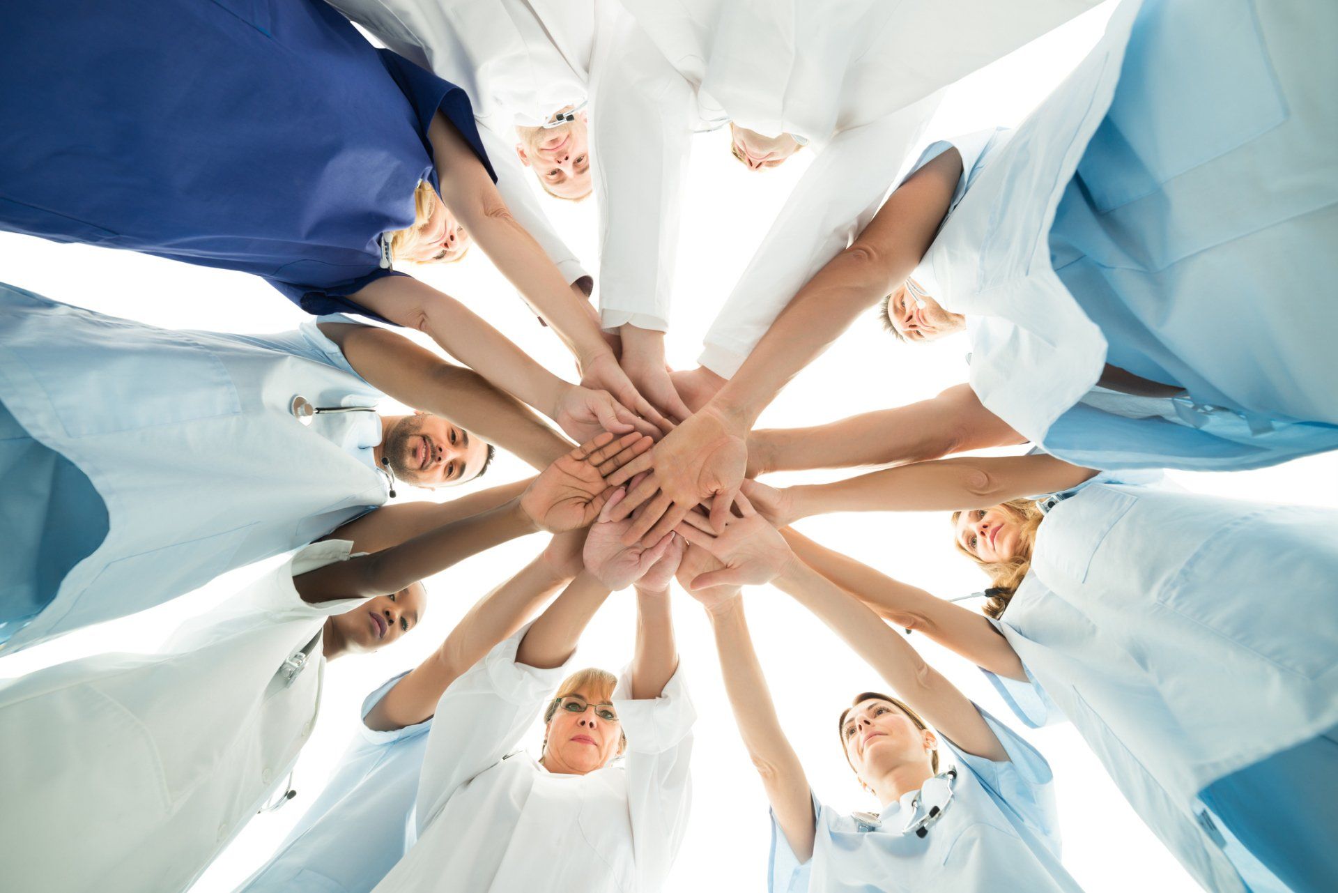 Medical Staffs with their Hands Together — Merritt Island, FL — Eye Clinic & Laser Institute
