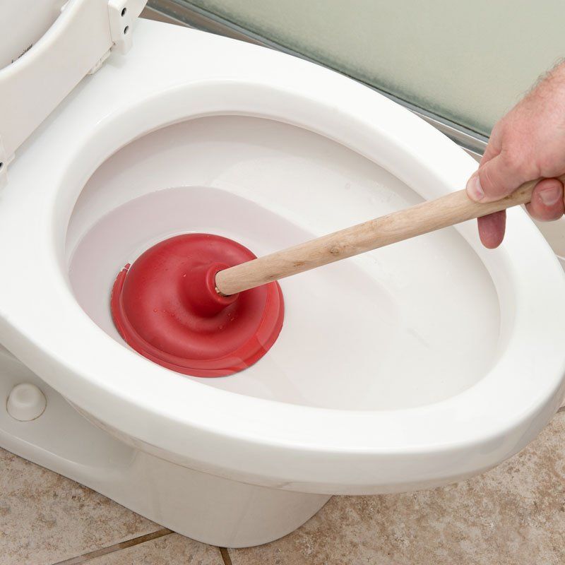 Plumber Uncloging Toilet — Ericson's Remodeling & Drain Cleaning, LLC
