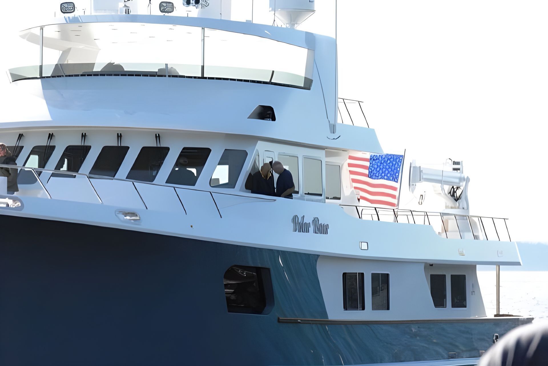 A boat is being towed by a trailer in the water