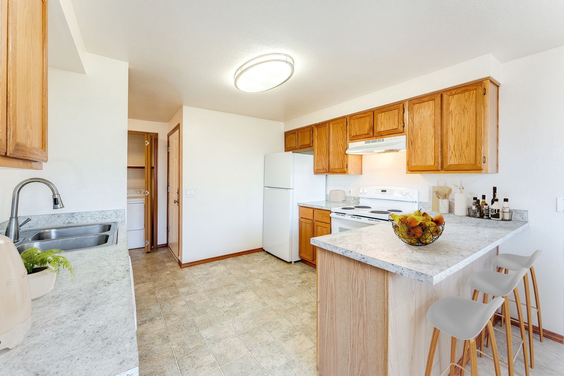 Kitchen fully equipped with fridge, range/oven, and dishwasher.