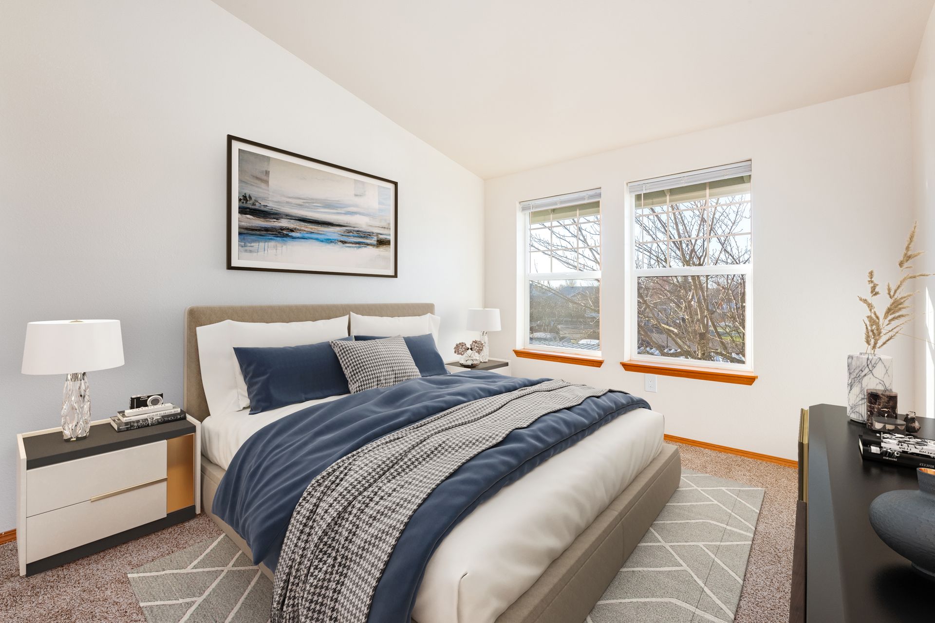Bedroom with view of two large windows.