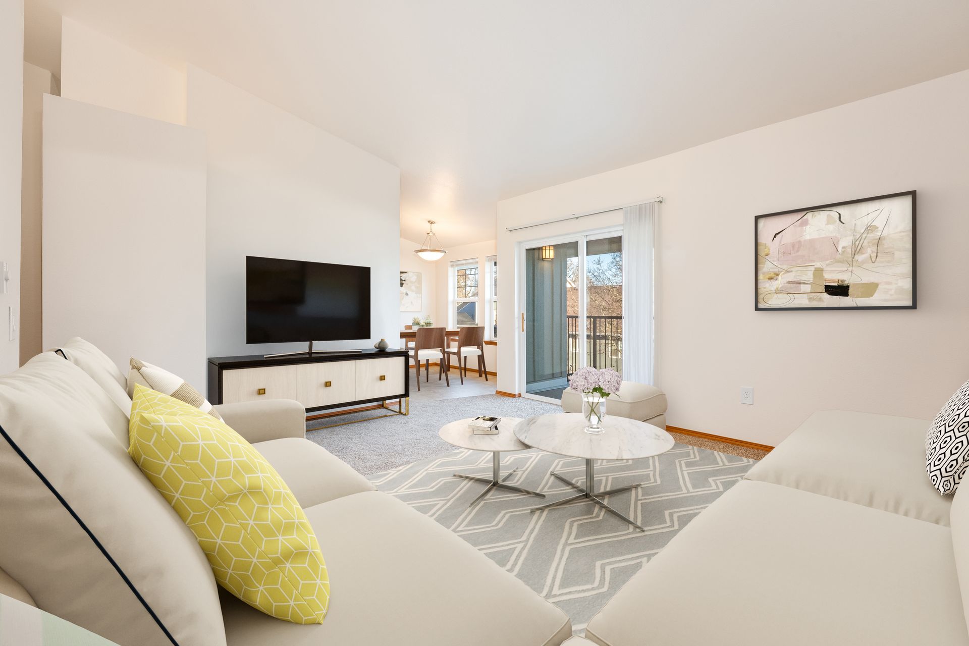 Living room with view of sliding glass doors and dining room in the background to the right.