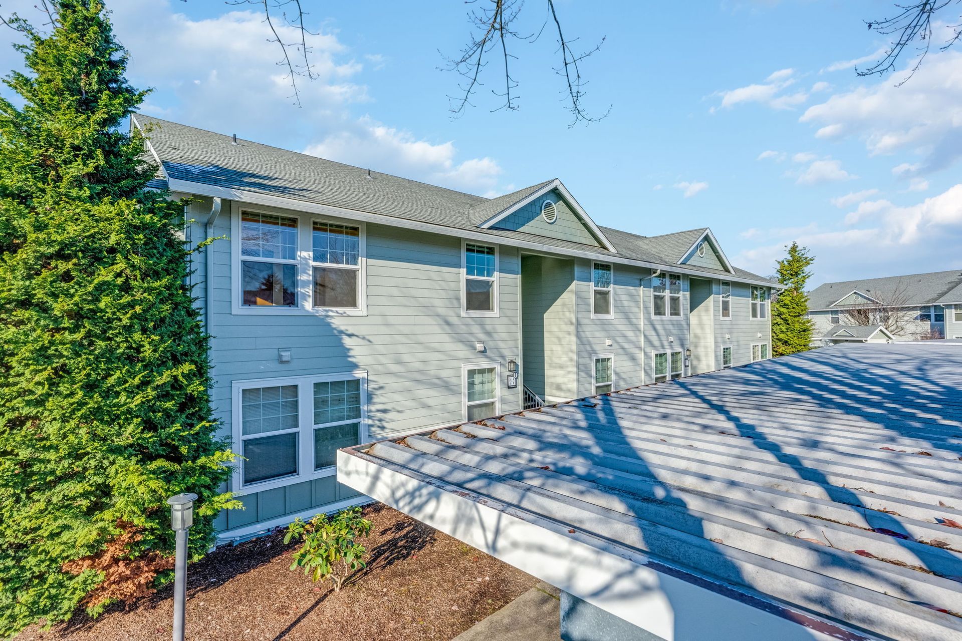 View of apartment building over covered parking.
