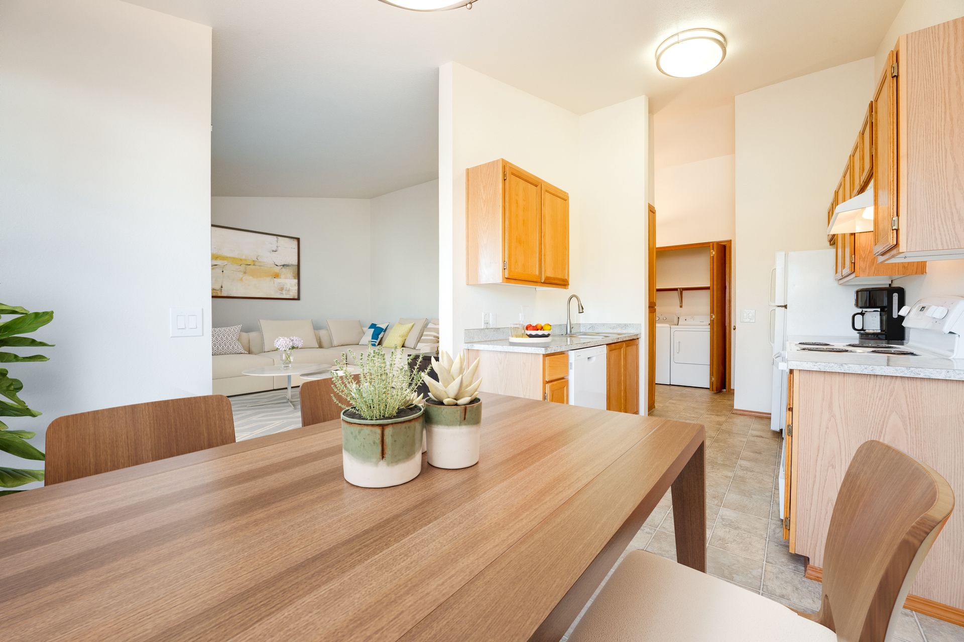 View from dining room with kitchen to the right and view of living room in the background to the left.