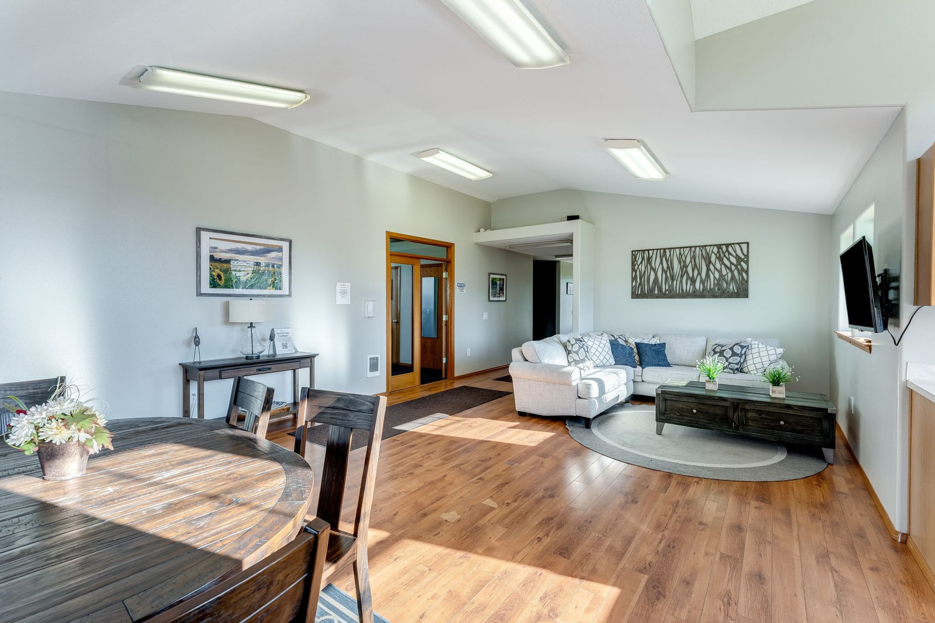 Recreation room with view of dining area and furnished living space in the background.