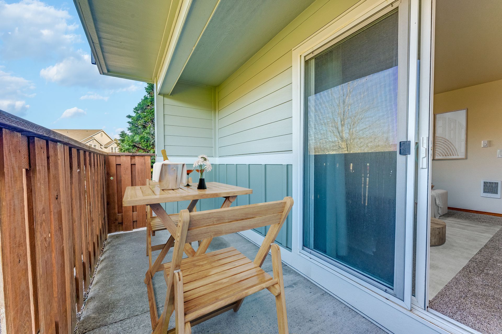 End apartment back patio off the living room through sliding glass door.