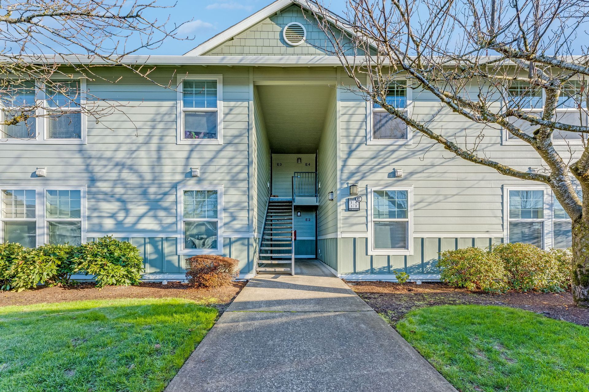 View of entryway at the end of sidewalk.