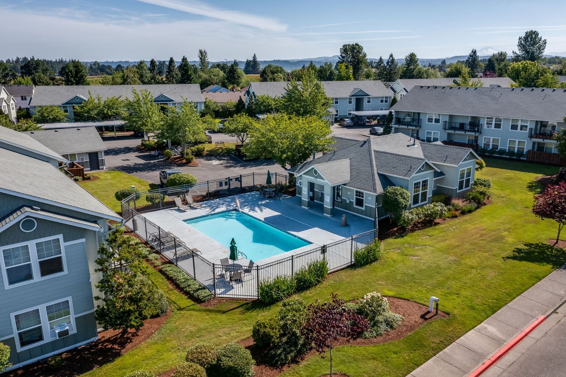 Aerial view of pool and surrounding buildings.
